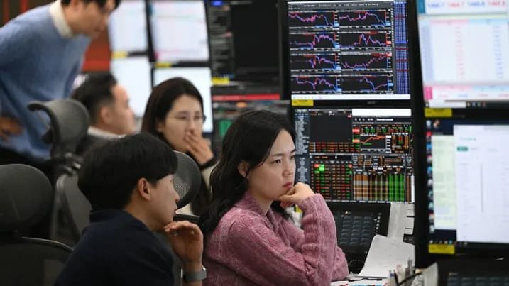 South Korea stock market traders monitor markets during a volatile Kospi session