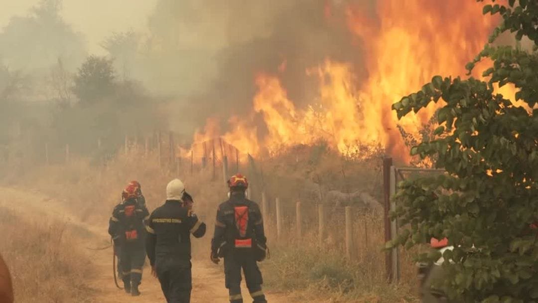 Firefighters battle a massive wildfire in Greece after two firefighting helicopters collided during operations.