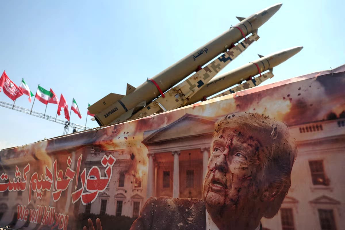 Banner showing U.S. President Donald Trump beside an Iranian missile system in Tehran amid rising Iran-US tensions.