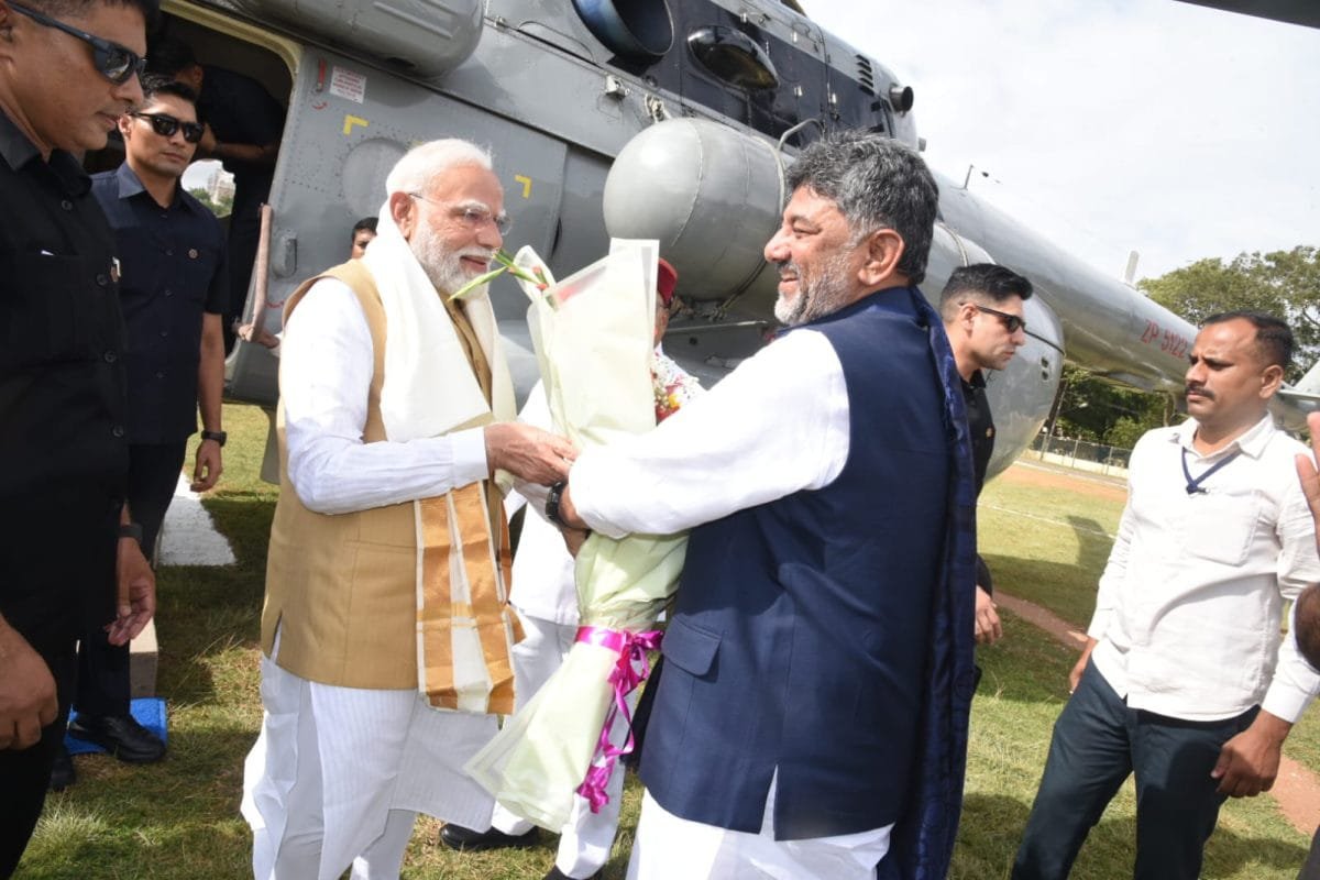 PM Modi Arrives in Mysuru, Received by Karnataka CM D.K. Shivakumar Ahead of Viveka Smaraka Inauguration PM Modi Arrives in Mysuru Ahead of Viveka Smaraka Inauguration