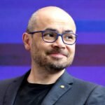Demis Hassabis speaking at an artificial intelligence summit after Alphabet announced major AI leadership changes.