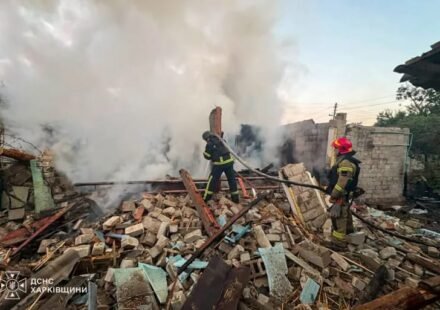 Firefighters work at the site of a house destroyed by a Russian drone strike in Ukraine