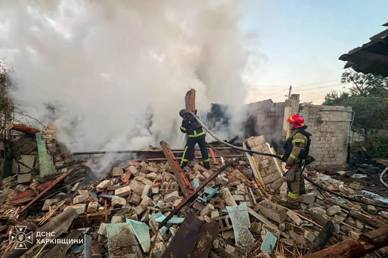  Firefighters work at the site of a house destroyed by a Russian drone strike in Ukraine