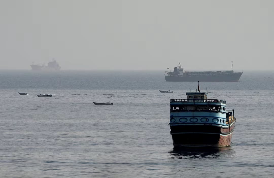 Ships sailing through the Strait of Hormuz as Iran and Oman discuss a temporary plan to reopen the strategic waterway.