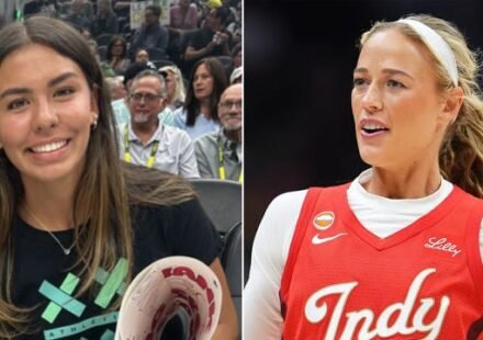 Ahnaleigh Wilson holding a Sophie Cunningham support sign during the Indiana Fever vs Seattle Storm WNBA game.