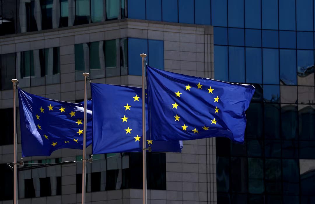 EU Approves €6.1 Billion Ukraine Defence Aid European Union flags outside European Commission headquarters as EU approves Ukraine defence aid
