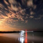 SpaceX Falcon 9 rocket launches Starlink satellites as the company reports strong Q2 2026 earnings driven by Starlink and AI growth.