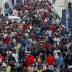 Migrants gather near the border in Spain's Ceuta enclave during a large-scale crossing from Morocco.