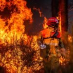 French firefighter works to contain a major wildfire near Saumos