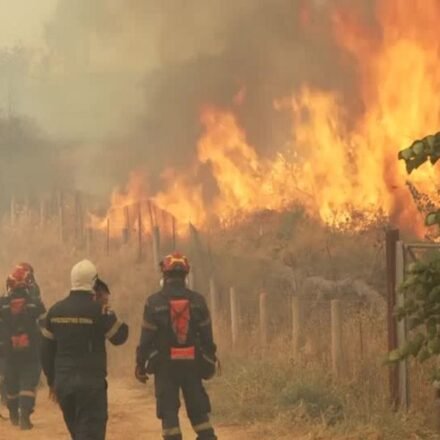 Firefighters battle a massive wildfire in Greece after two firefighting helicopters collided during operations.