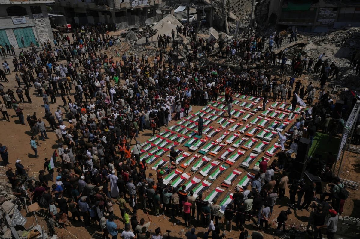 Palestinians Hold Mass Funeral After More Than 100 Bodies Recovered From 2023 Gaza Strike Palestinians attend a mass funeral after 112 bodies were recovered from the rubble of a 2023 strike in Gaza.