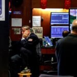 Traders work on the floor of the New York Stock Exchange during mixed trading on August 6, 2026.