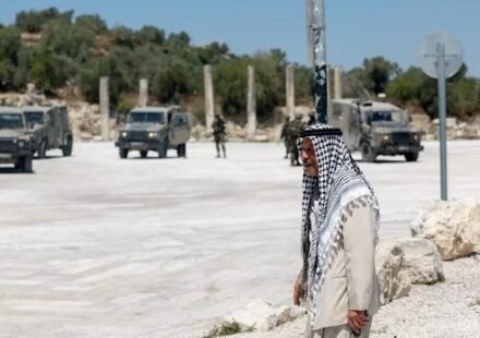 Palestinian man near Israeli troops at the archaeological site of Sebastia in the occupied West Bank