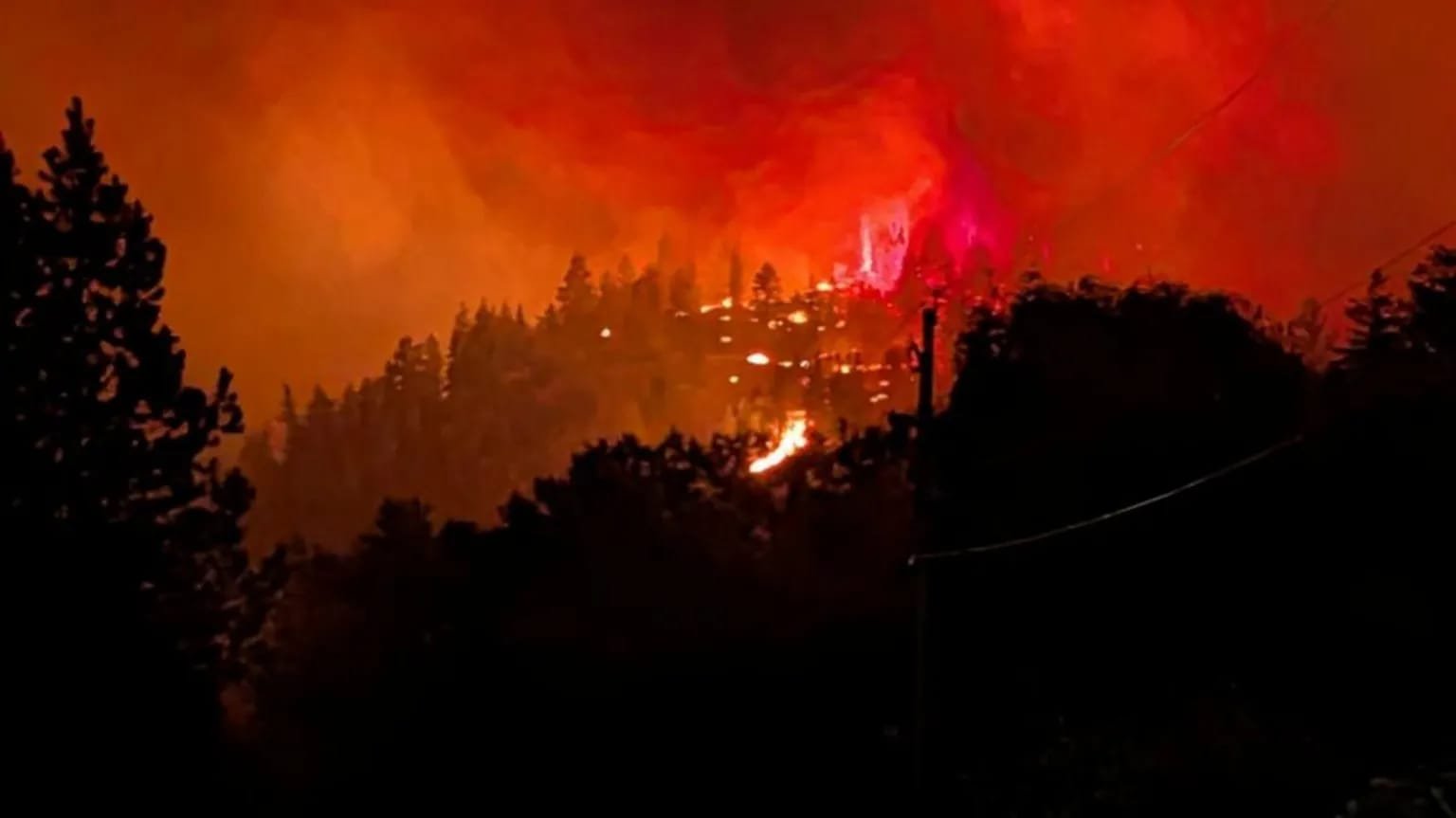 Canada Wildfire Doubles in Size, Forcing Thousands to Flee Smoke rises from the Bald Range wildfire over a residential street in Summerland, British Columbia