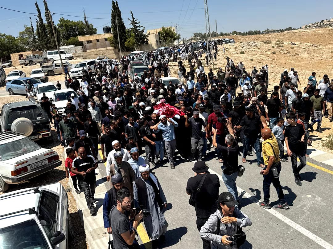 Mourners carry the body of Palestinian activist Owdeh Hathaleen during his funeral near Hebron in the occupied West Bank.